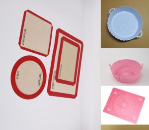 Silicone baking mat rolled on a tray next to parchment paper